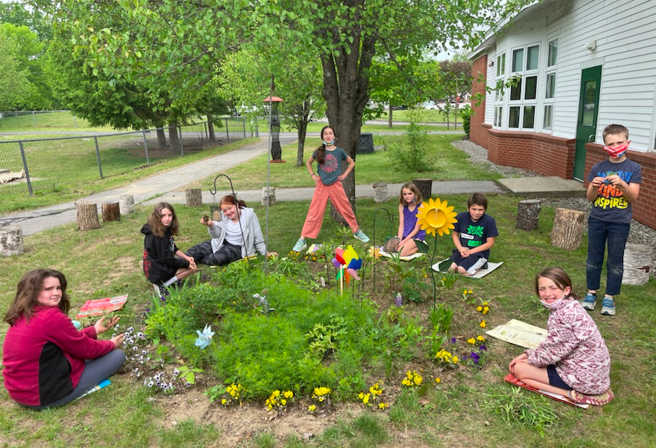 Students around flower garden